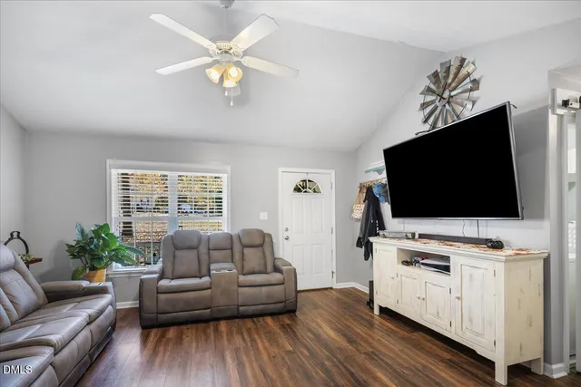 a living room with furniture and a flat screen tv