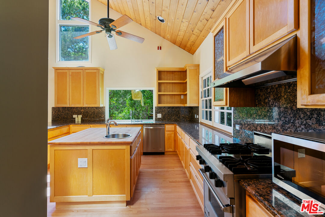 20912 Fontaine Road Topanga, CA 90290 - Photo 11 of 52 a kitchen with a sink a counter top space and stainless steel appliances