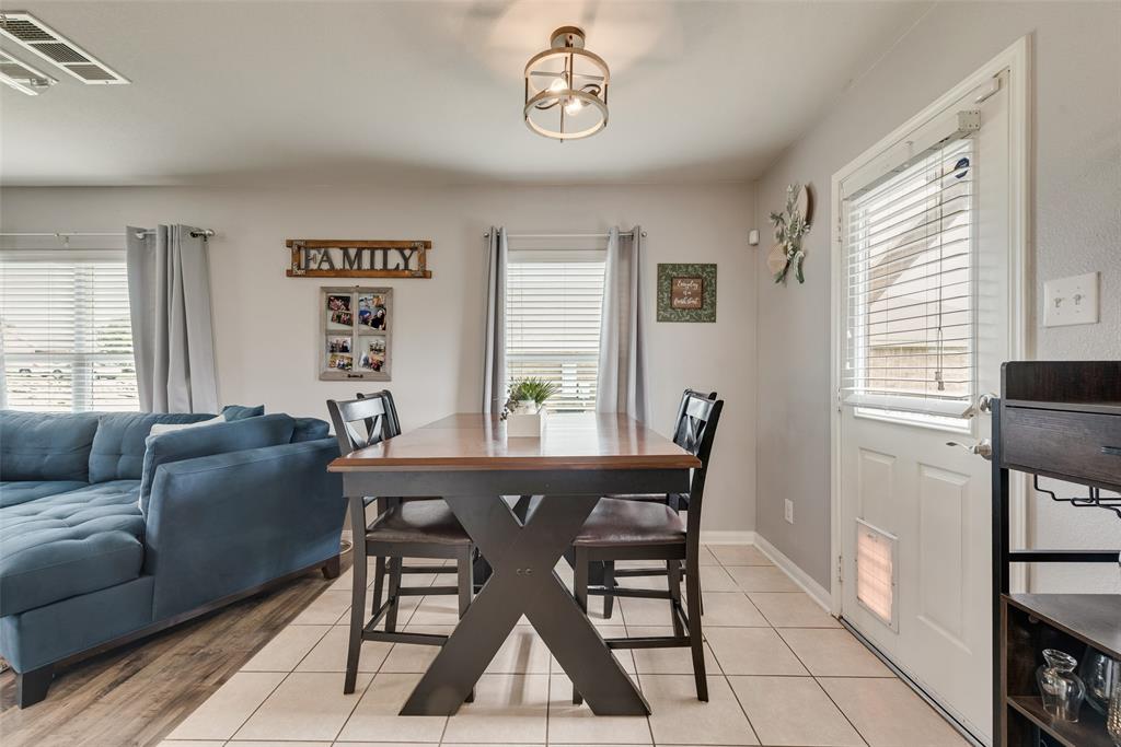 149 Cattlemans Creek Road Newark, TX 76071 - Photo 13 of 39 Dining area with lots of natural light and door to backyard at 149 Cattlemans Creek Rd in the Chisholm Springs neighborhood in Newark, TX 76071