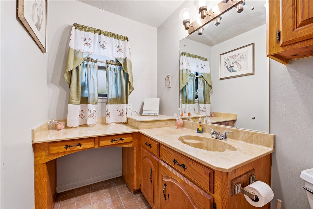 706 Mesquite Street Calvert, TX 77837 - Photo 17 of 23 a bathroom with a sink and a mirror
