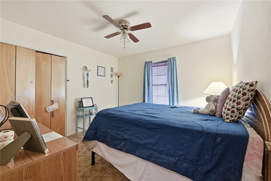 706 Mesquite Street Calvert, TX 77837 - Photo 18 of 23 a bedroom with a bed and a dresser
