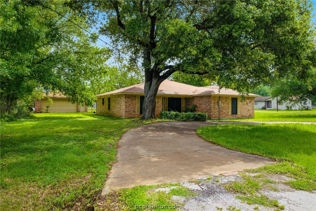 706 Mesquite Street Calvert, TX 77837 - Photo 2 of 23 a front view of a house with a yard