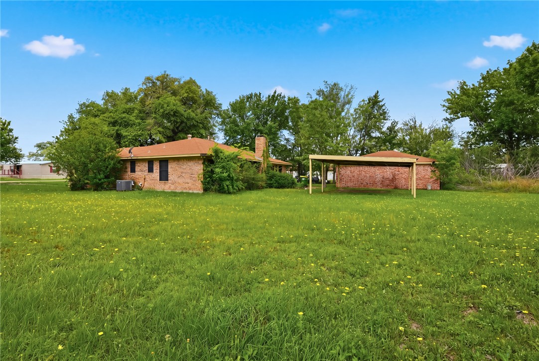 706 Mesquite Street Calvert, TX 77837 - Photo 21 of 23 a view of a house with a yard