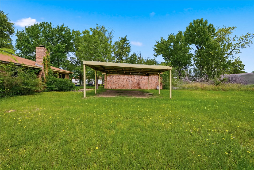 706 Mesquite Street Calvert, TX 77837 - Photo 22 of 23 a view of a back yard with a garden
