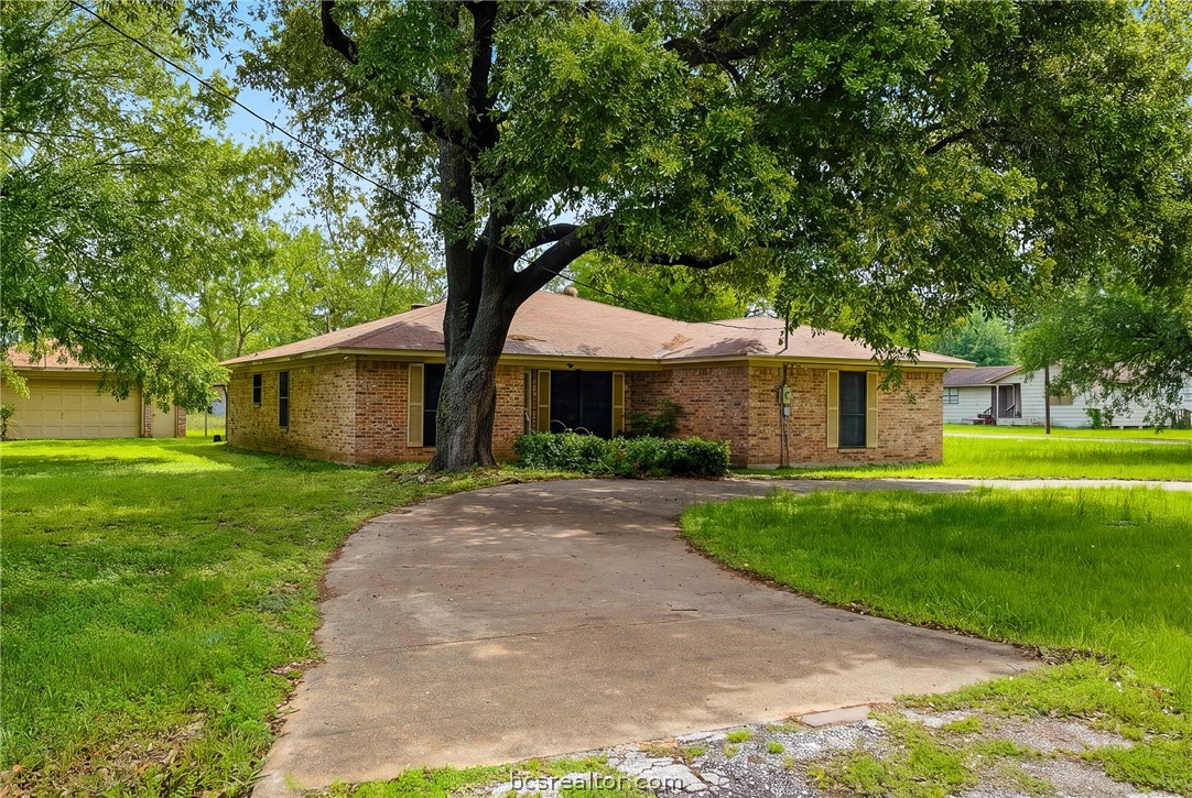 706 Mesquite Street Calvert, TX 77837 - Photo 3 of 23 a front view of a house with a yard
