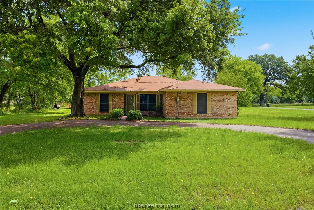 706 Mesquite Street Calvert, TX 77837 - Photo 6 of 23 a front view of a house with a garden