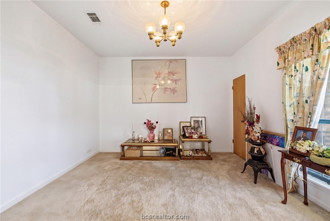 706 Mesquite Street Calvert, TX 77837 - Photo 8 of 23 a view of room with toys and a chandelier