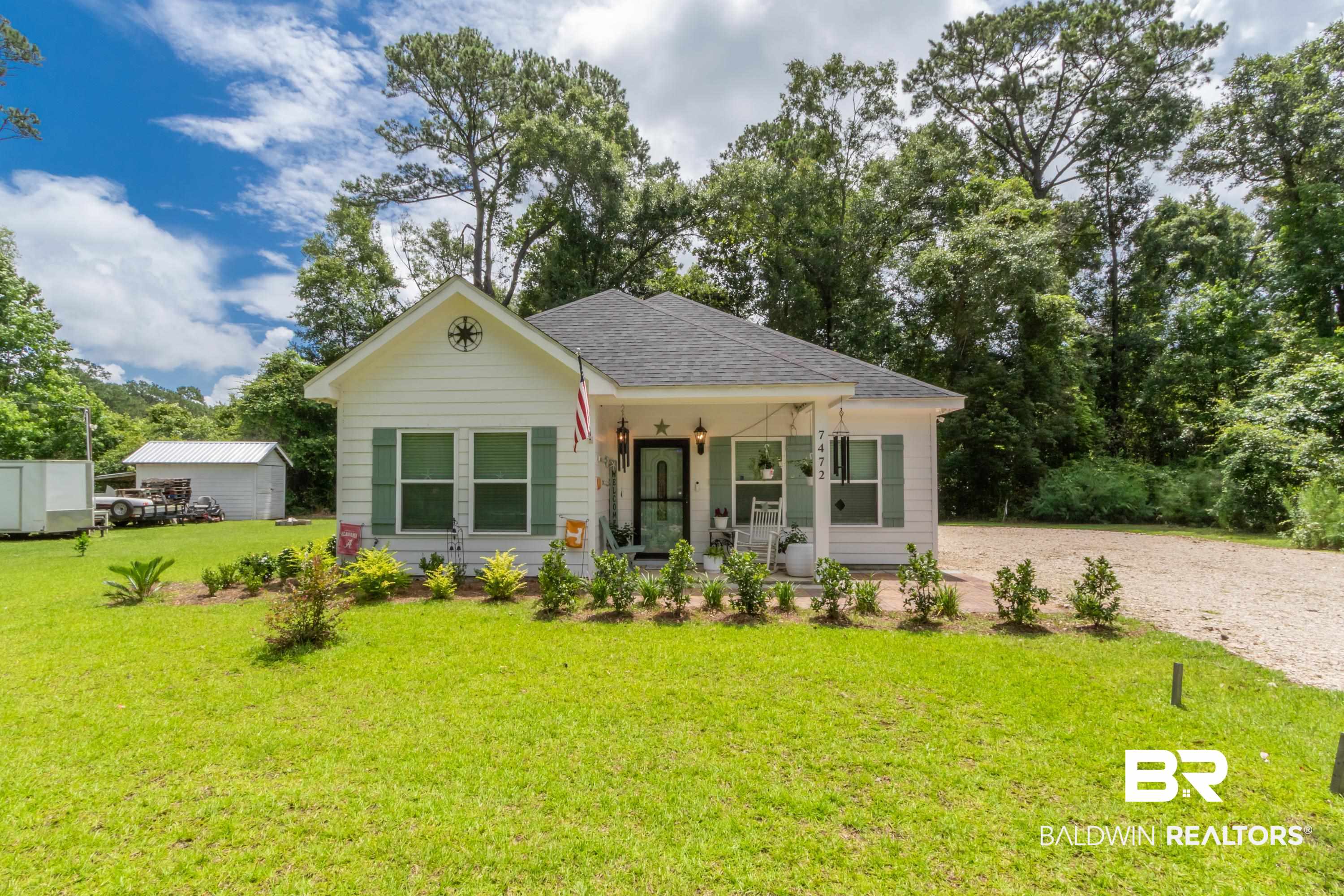 7472 Coopers Landing Road Foley, AL 36535 - Photo 28 of 40 White siding exterior with green window shutters