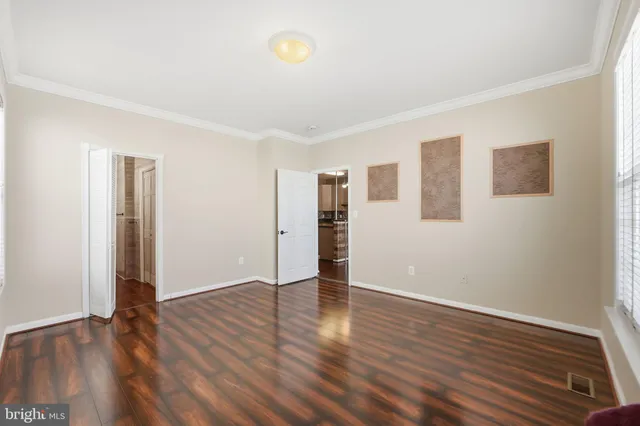 a bedroom with a bed potted plant and a dresser