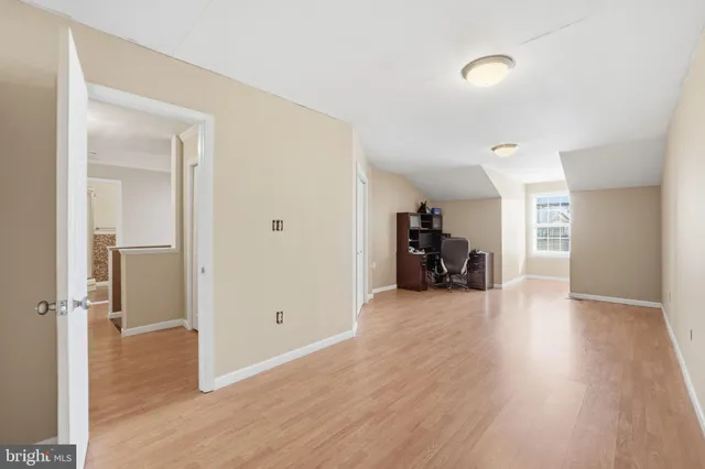 a view of a big room with wooden floor and furniture
