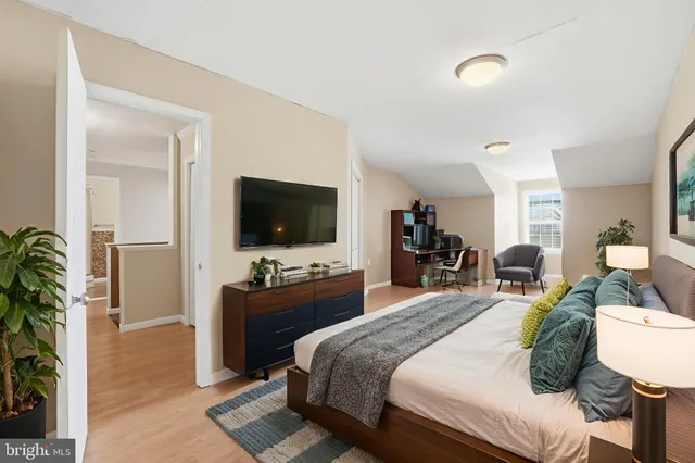 a view of room with wooden floor and furniture