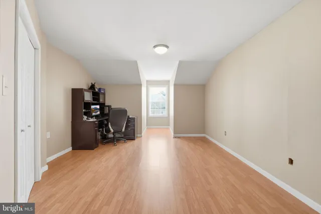 a bathroom with a granite countertop toilet sink and mirror