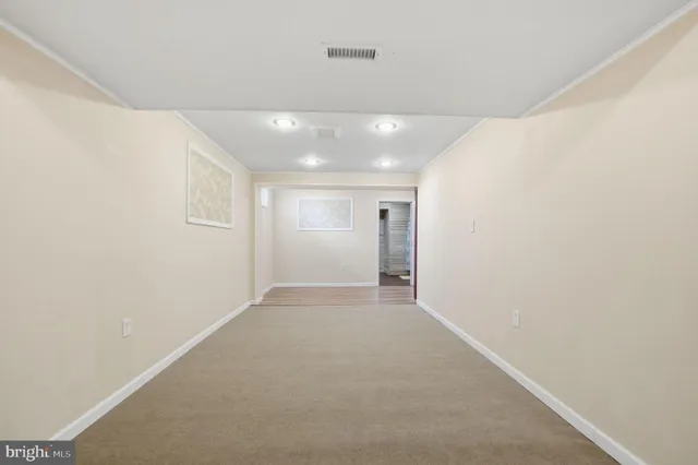 a view of an empty room and wooden floor