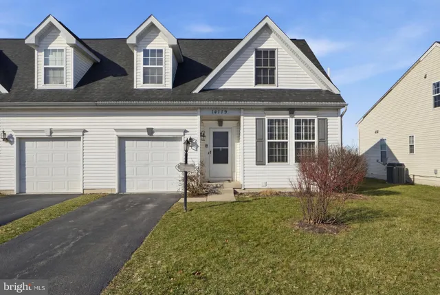 a view of a back yard of the house with a patio