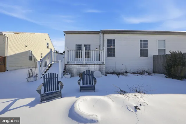 a view of a house with snow on the road