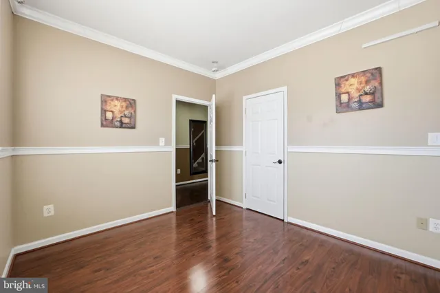 an empty room with wooden floor and closet