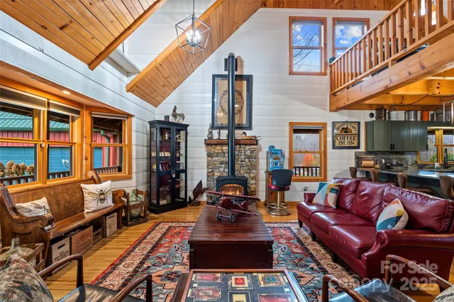 a living room with furniture a fireplace and a large window