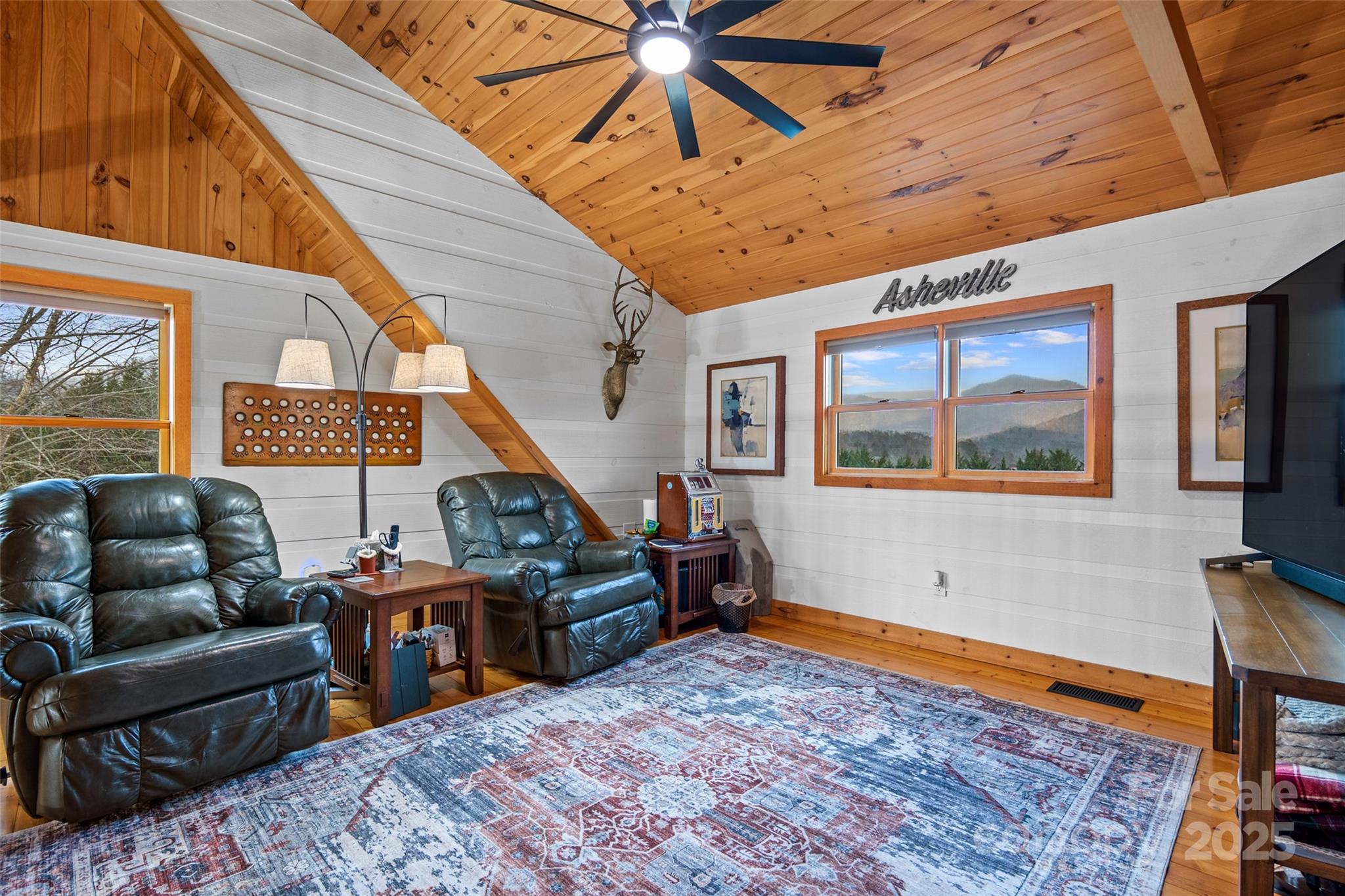 145 Keener Road Canton, NC 28716 - Photo 35 of 48 a living room with furniture a rug and a large window