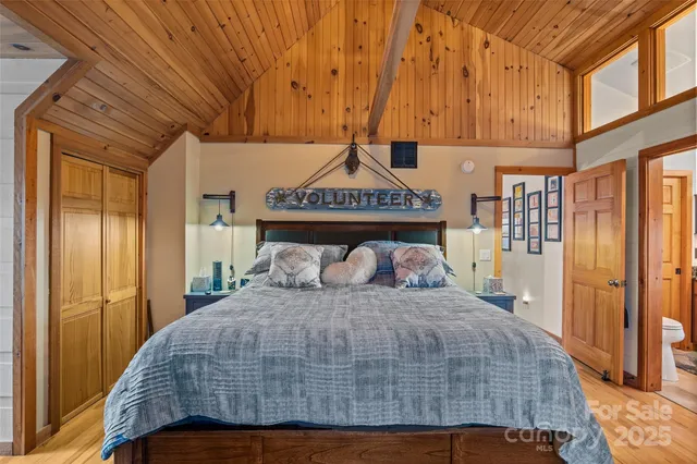 a bedroom with a large bed and a chandelier