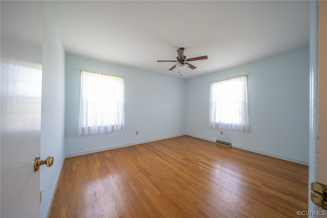 501 Country Club Road Keysville, VA 23947 - Photo 8 of 14 a view of an empty room with wooden floor and a window