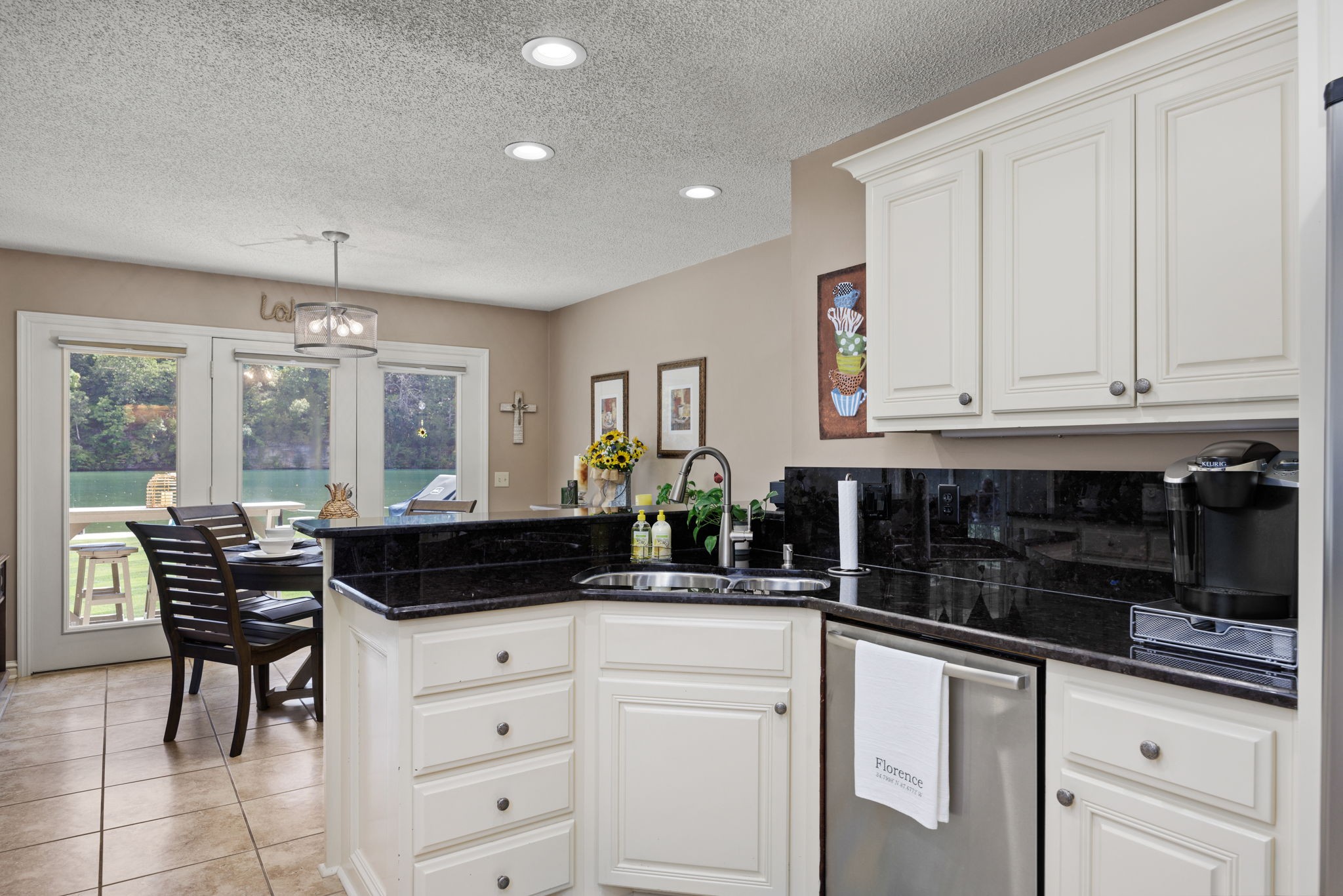568 County Road 322 Florence, AL 35634 - Photo 14 of 60 a kitchen with granite countertop white cabinets and black appliances