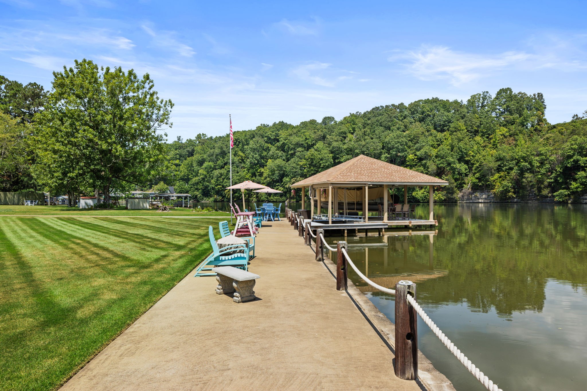 568 County Road 322 Florence, AL 35634 - Photo 39 of 60 a roof deck with table and chairs under an umbrella