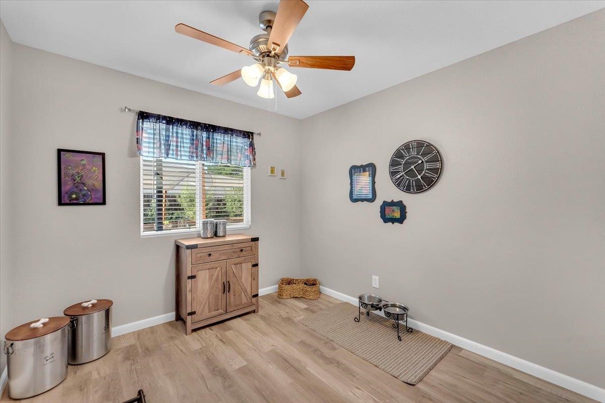 2110 Gentry Way Red Bluff, CA 96080 - Photo 23 of 47 a spacious bedroom with a bed and a chandelier