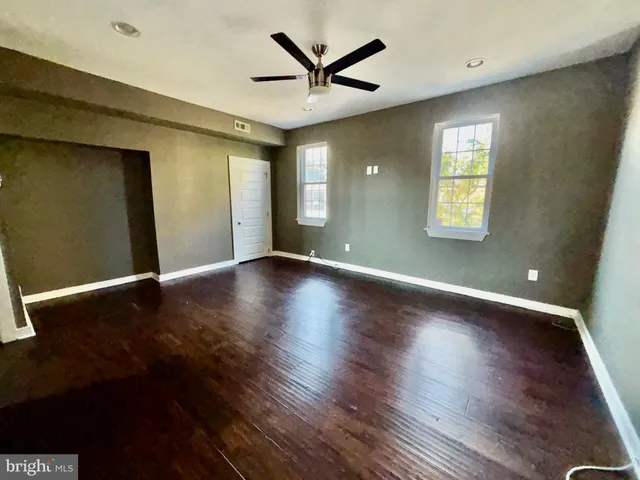 a view of a livingroom with a hardwood floor and a ceiling fan