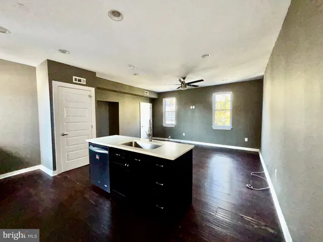 a view of a kitchen cabinets a sink and wooden floor