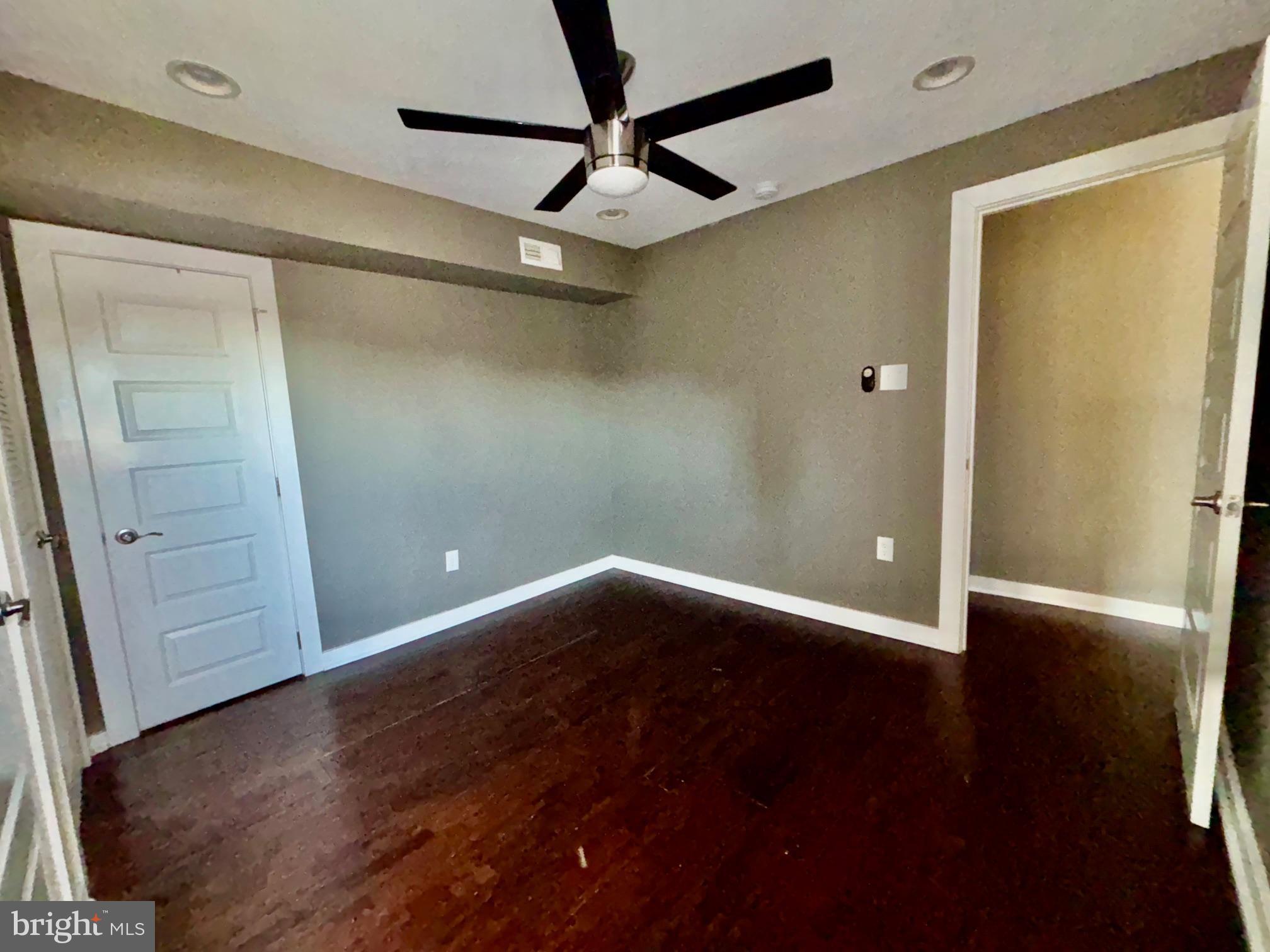 1865 Frankford Avenue, Unit B Philadelphia, PA 19125 - Photo 10 of 12 an empty room with wooden floor and fan