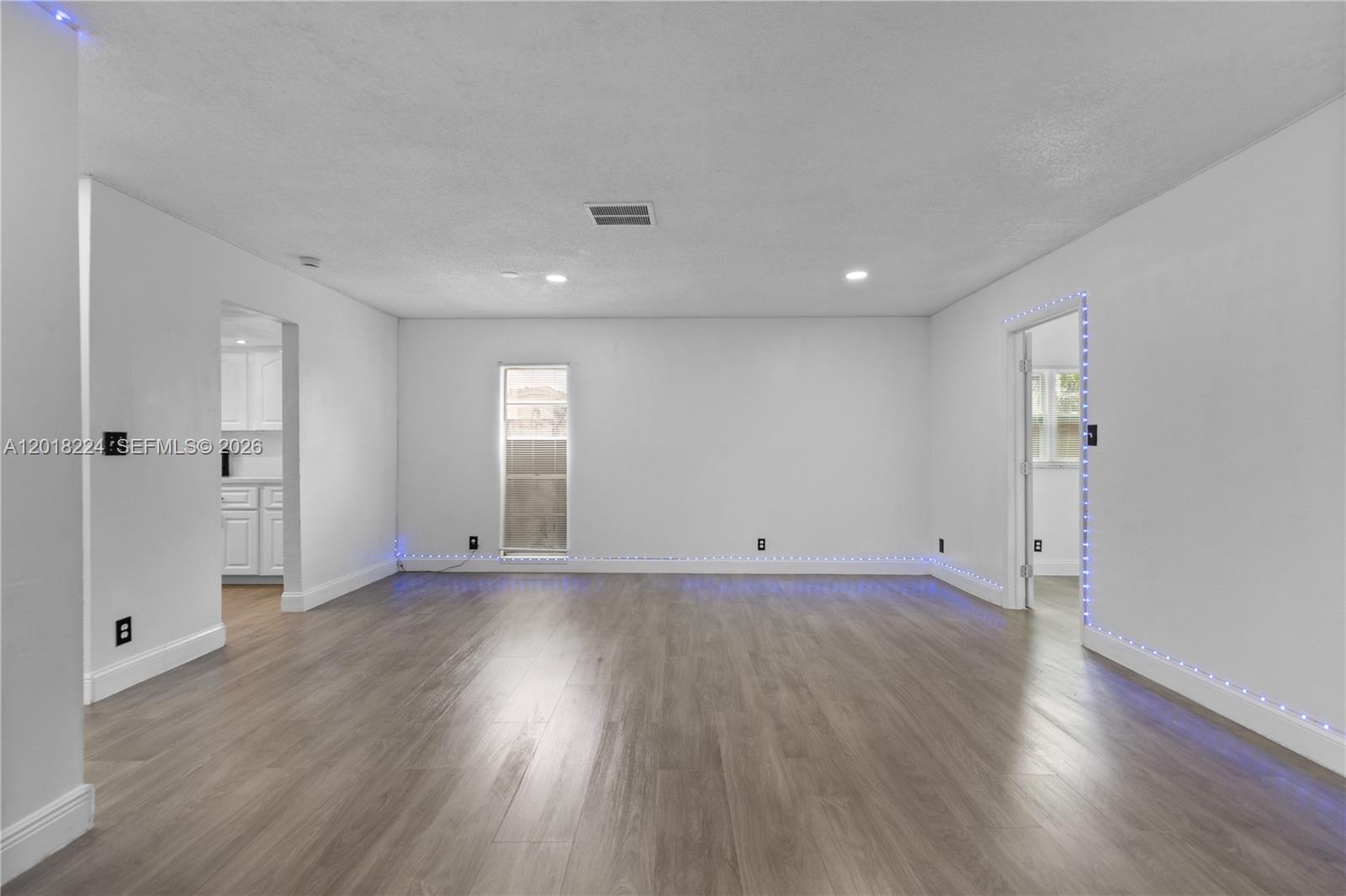 7958 Southwest 6th Street Pompano Beach, FL 33068 - Photo 15 of 57 an empty room with wooden floor and window
