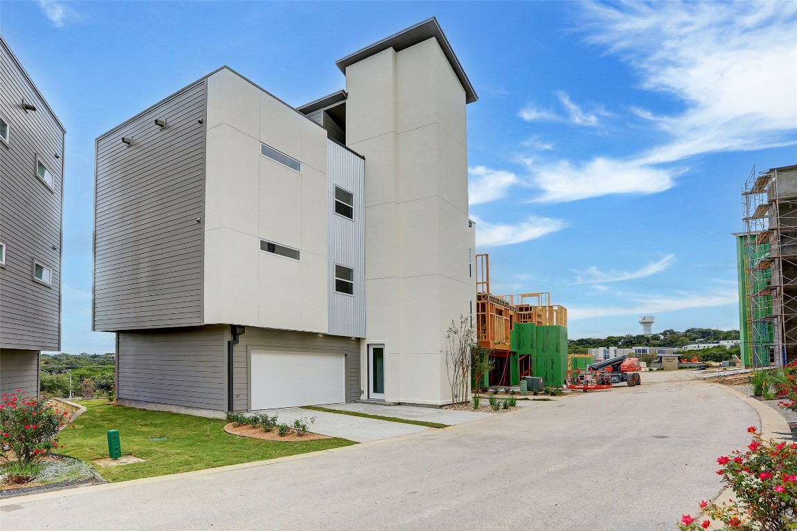 a city view with tall buildings and a yard