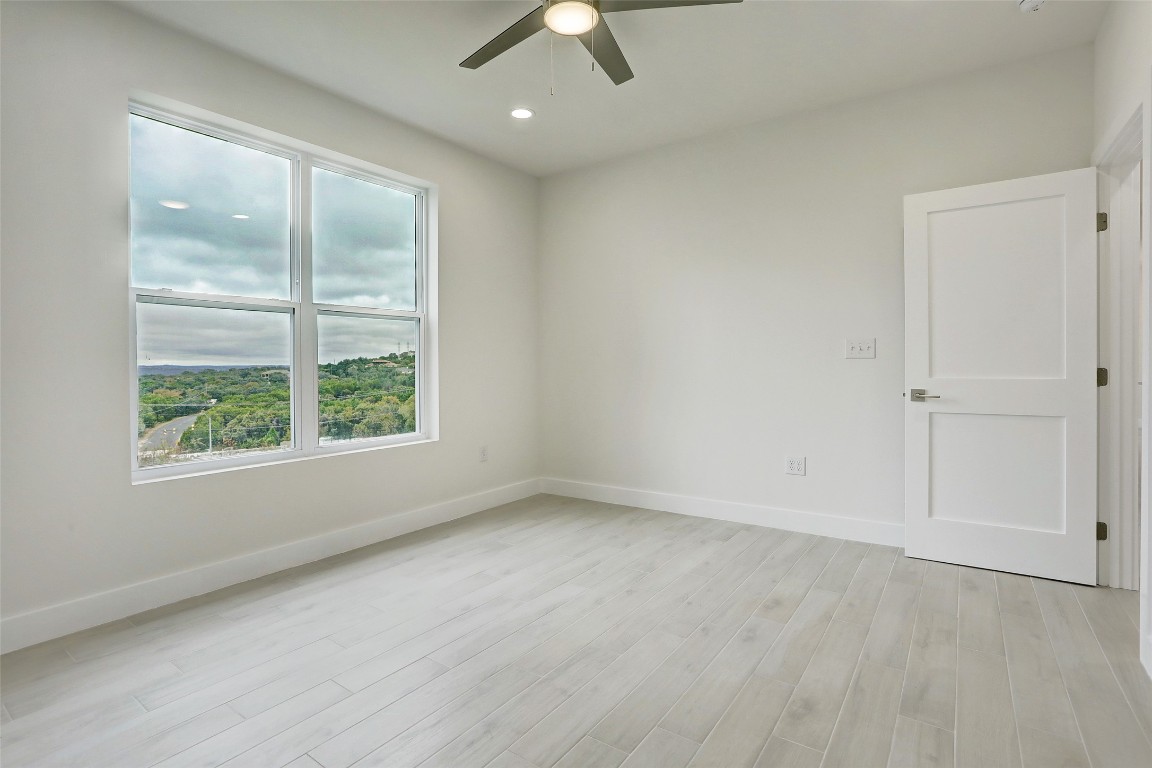4300 Mansfield Dam Road, Unit 1421 / 1431 Austin, TX 78734 - Photo 18 of 32 an empty room with a window and a ceiling fan