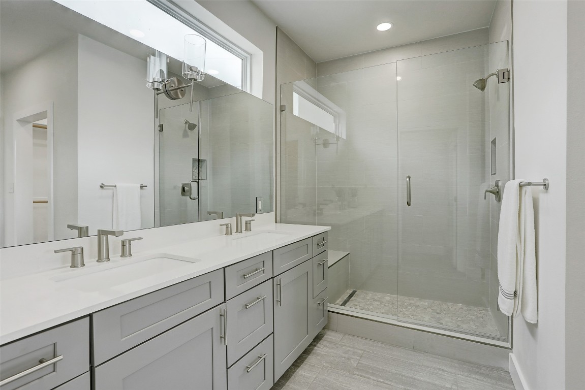 4300 Mansfield Dam Road, Unit 1421 / 1431 Austin, TX 78734 - Photo 22 of 32 a bathroom with a shower sink and mirror