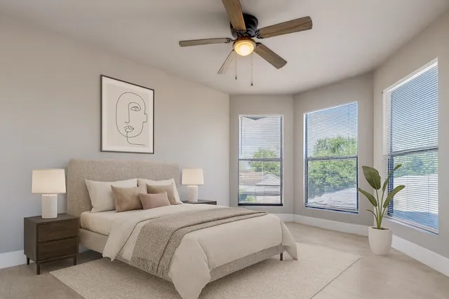 a bedroom with a large bed and a large window