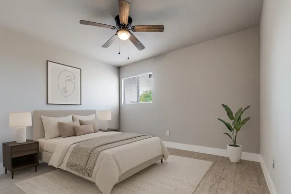 a bedroom with a large bed and a chandelier