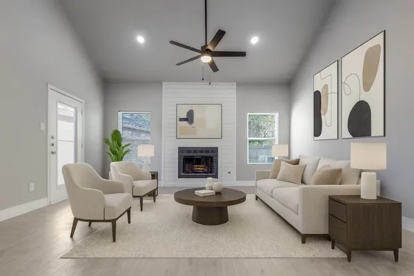 a living room with furniture a fireplace and a large mirror
