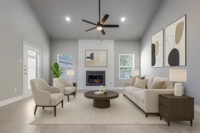 a living room with furniture a fireplace and a large mirror