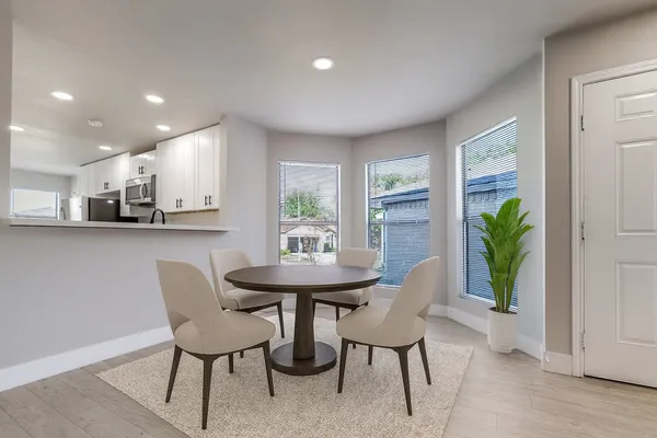 a view of a dining room with furniture and a potted plant