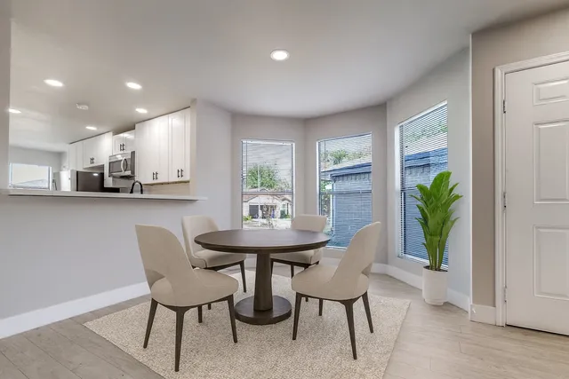 a view of a dining room with furniture and a potted plant