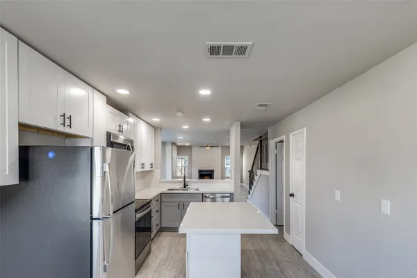 a kitchen with stainless steel appliances a refrigerator and a stove