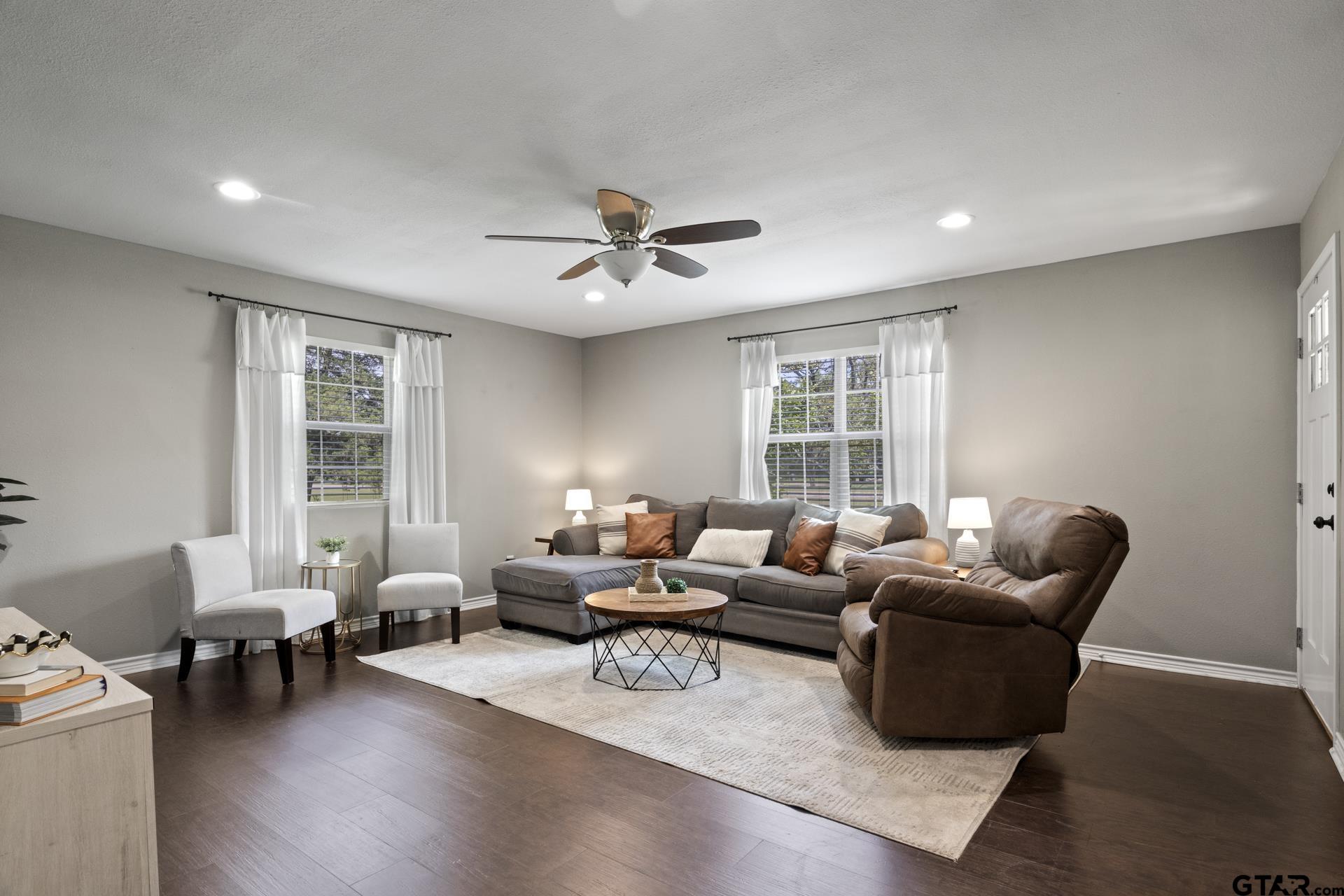 655 Daingerfield Street Pittsburg, TX 75686 - Photo 5 of 27 a living room with furniture and a large window