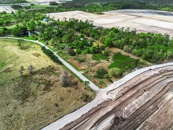 a view of a yard with a wooden fence
