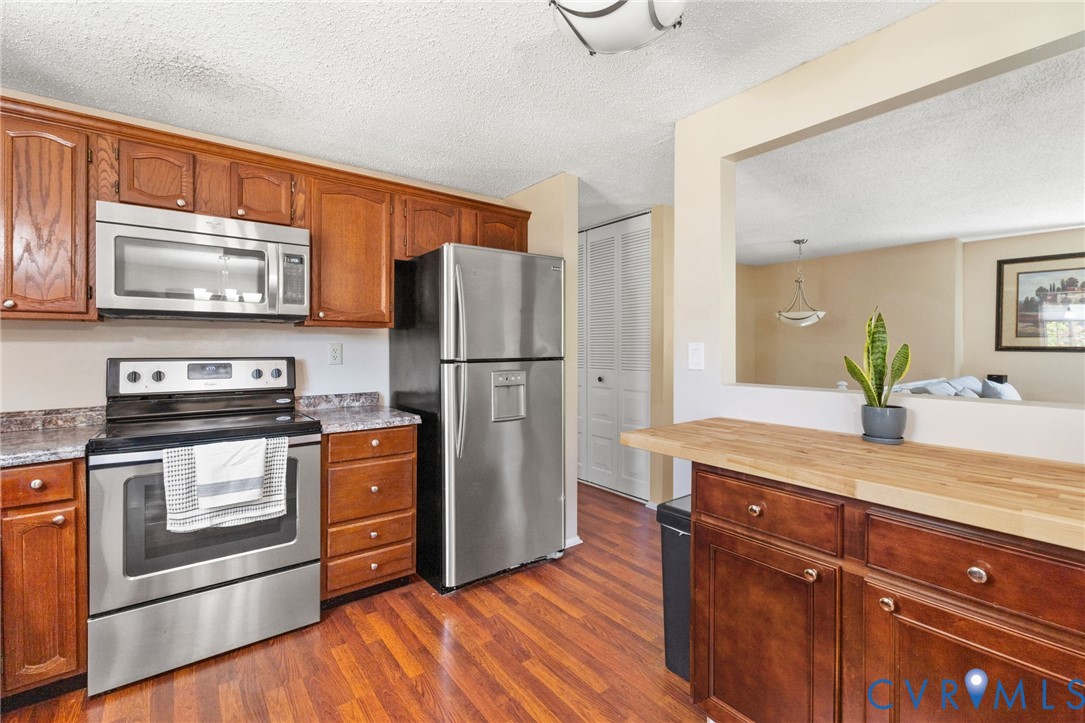 100 Moorwood Ridge Drive Chesterfield, VA 23236 - Photo 8 of 24 a kitchen with stainless steel appliances granite countertop a refrigerator stove and microwave