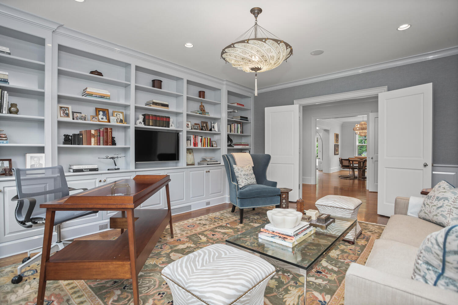 3 Half Mile Road Darien, CT 06820 - Photo 20 of 49 a living room with furniture a rug and a bookshelf