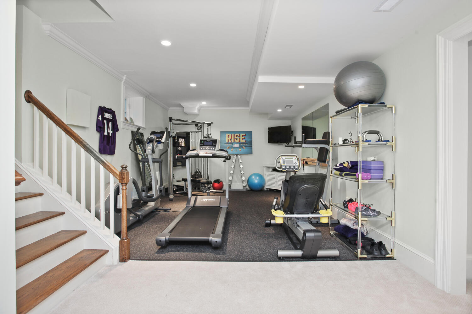 3 Half Mile Road Darien, CT 06820 - Photo 34 of 49 a room with lots of gym equipment and a chandelier