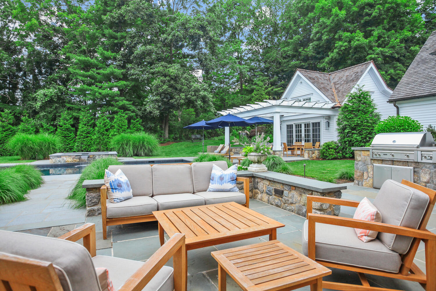 3 Half Mile Road Darien, CT 06820 - Photo 42 of 49 a view of a patio with couches table and chairs with wooden fence