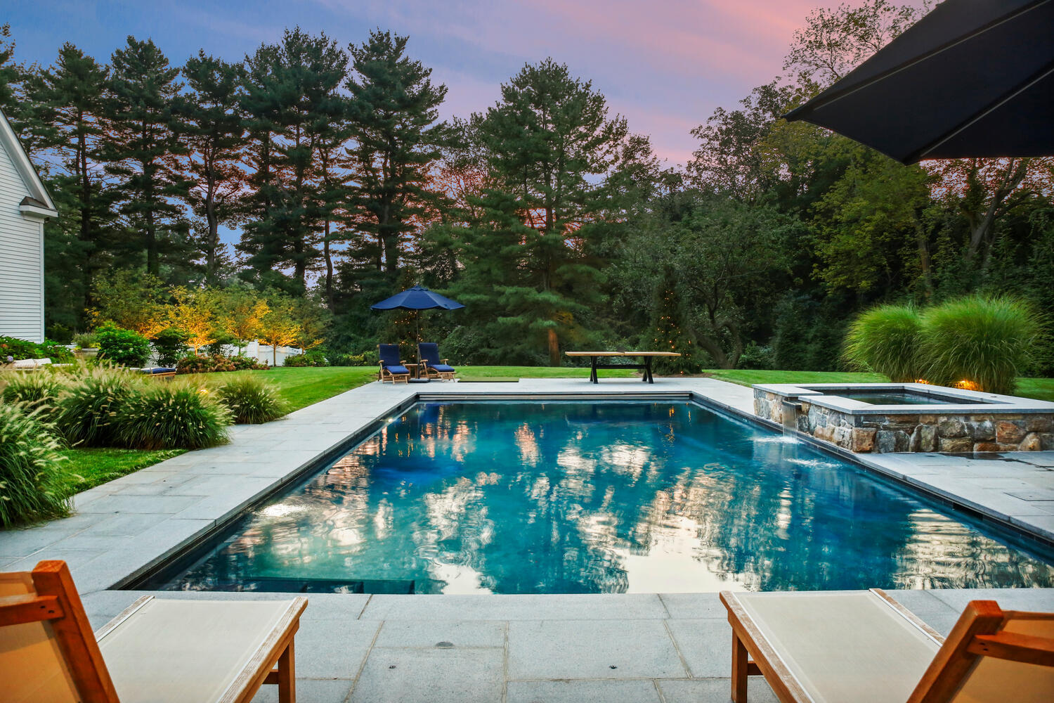 3 Half Mile Road Darien, CT 06820 - Photo 7 of 49 a view of swimming pool with seating area and trees in the background