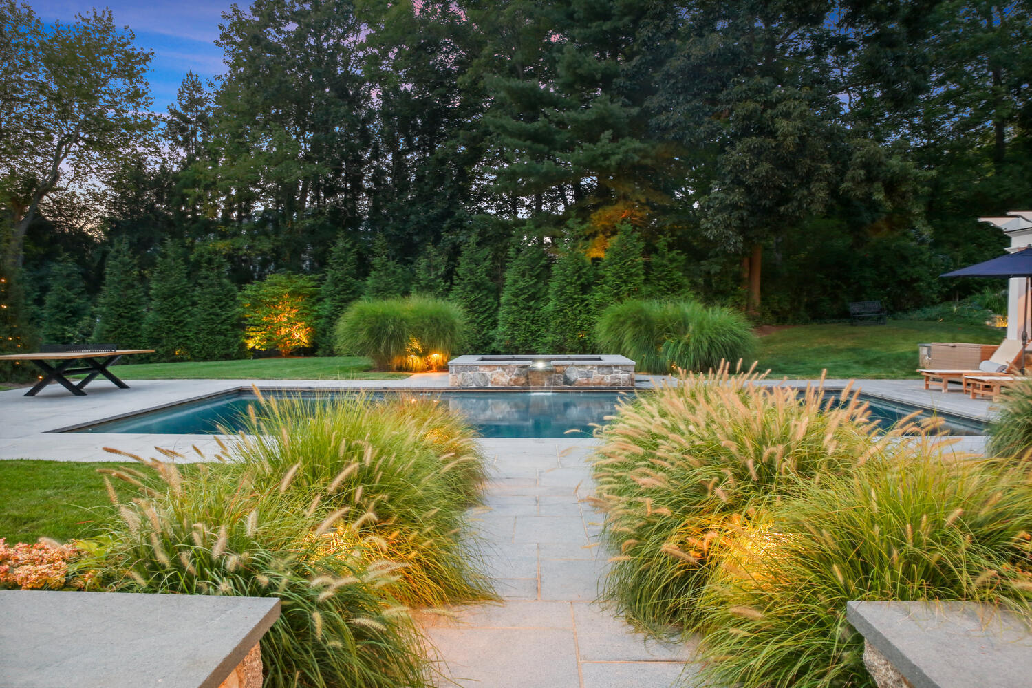 3 Half Mile Road Darien, CT 06820 - Photo 8 of 49 a view of a swimming pool with a lawn chairs under an umbrella