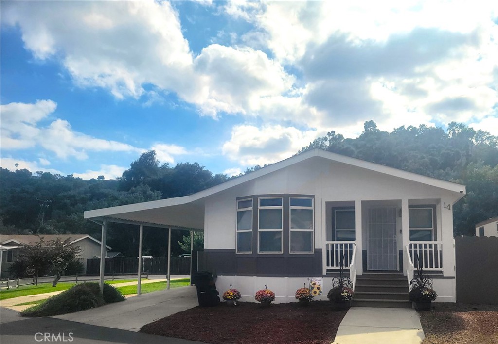 3909 Reche Road, Unit 14 Fallbrook, CA 92028 - Photo 1 of 1 a view of a house with yard and sitting area